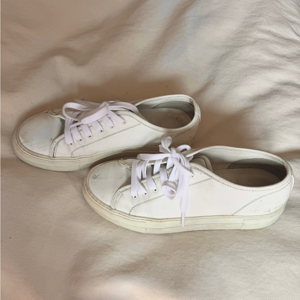 Pretty worn in common project sneakers